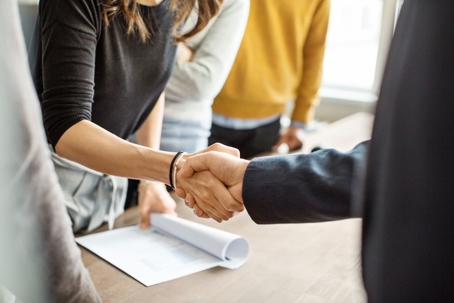 client shaking hands of attorney